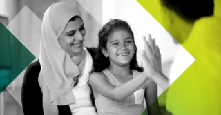 A woman and her daughter laughing.