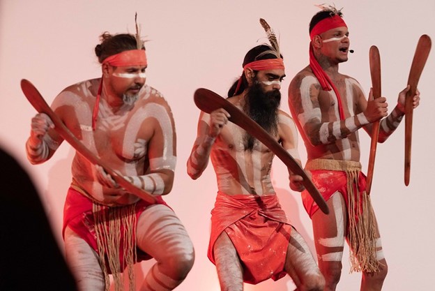 A photo of natives dancing on stage